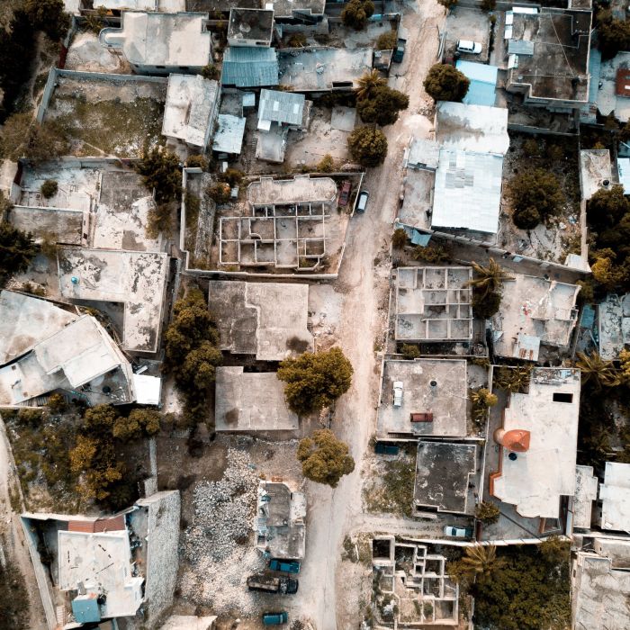 Overhead shot of a road in the middle of old buildings and trees